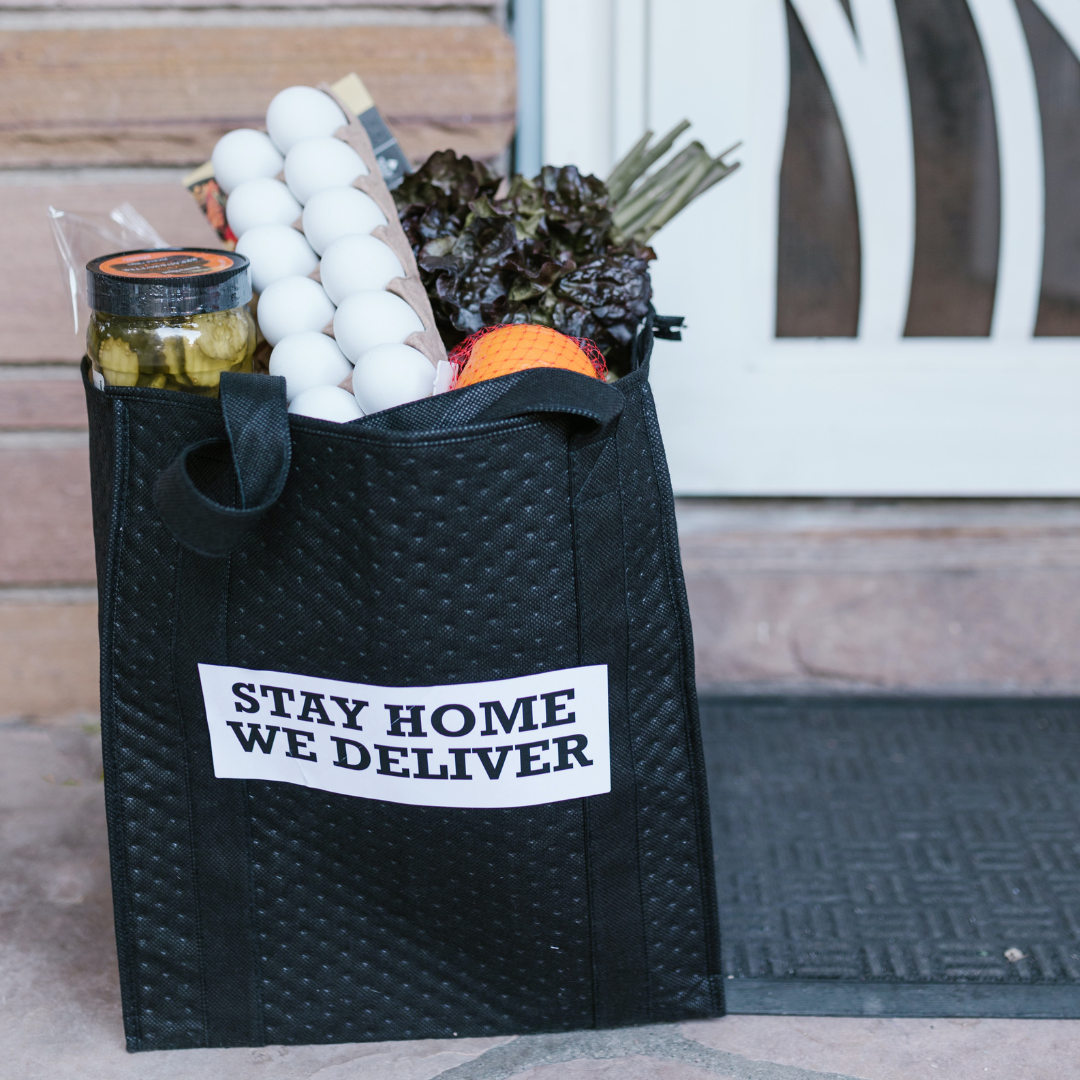 black shopping tote with food on porch